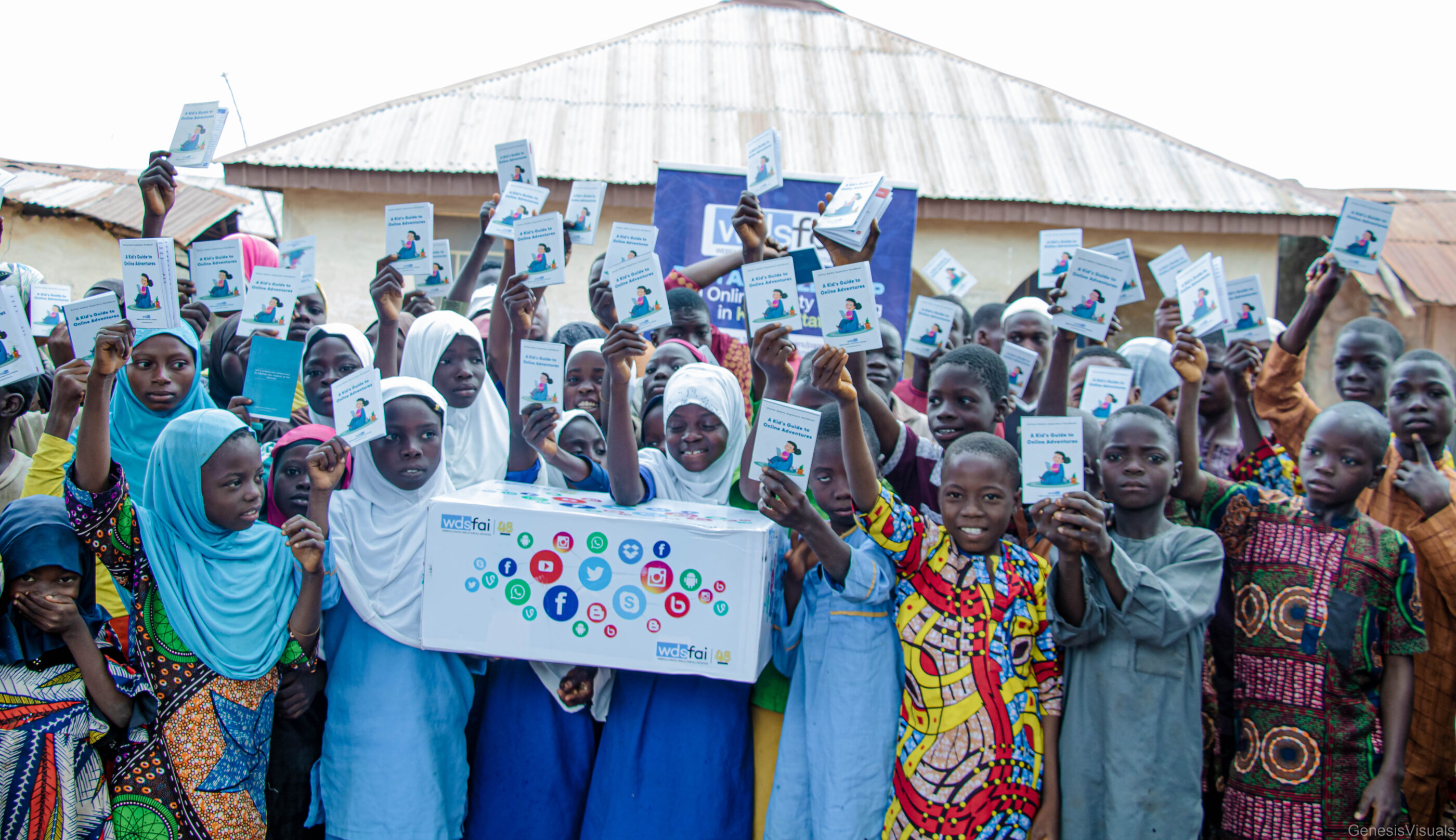 A diverse group of children in hijabs proudly holds their voting cards after completing a digital safeguarding course.